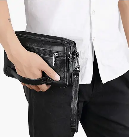 man holding a clutch purse wristlet